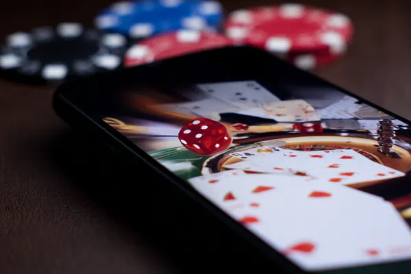 A professional dealer in a tuxedo greeting players at the roulette table, symbolizing the authentic live casino feel at T9999.