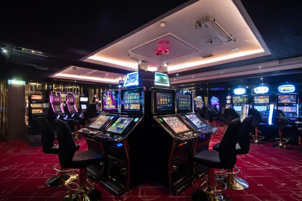 A woman in a luxurious green gown next to an ornate roulette wheel, capturing the upscale casino mood of T9999.